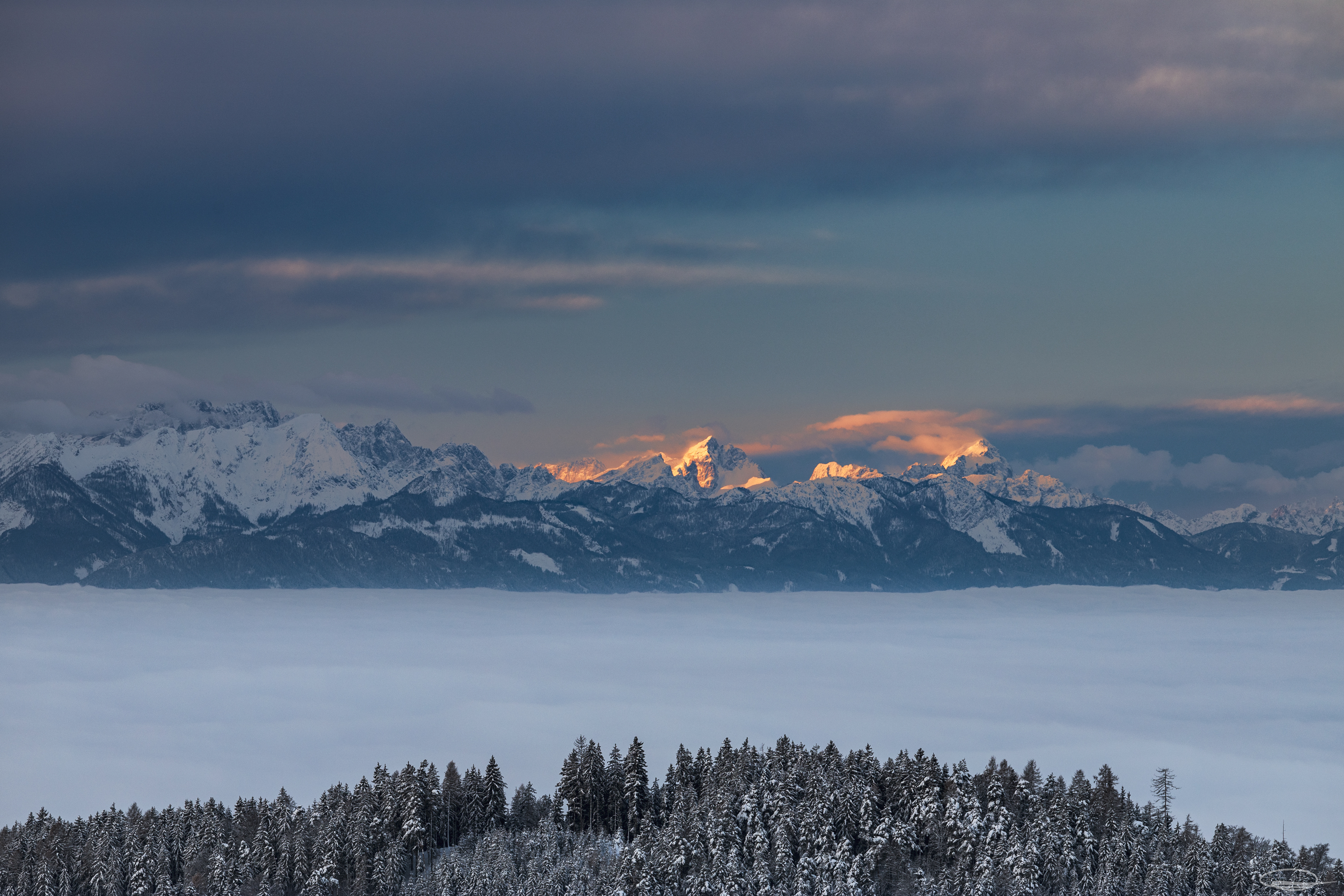 Mountain Glow over the foggy valley